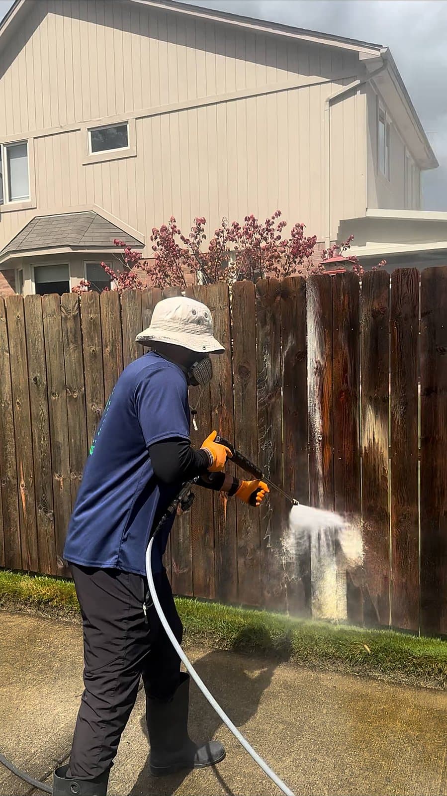 Wood fence being washed clean board by board in Macomb County