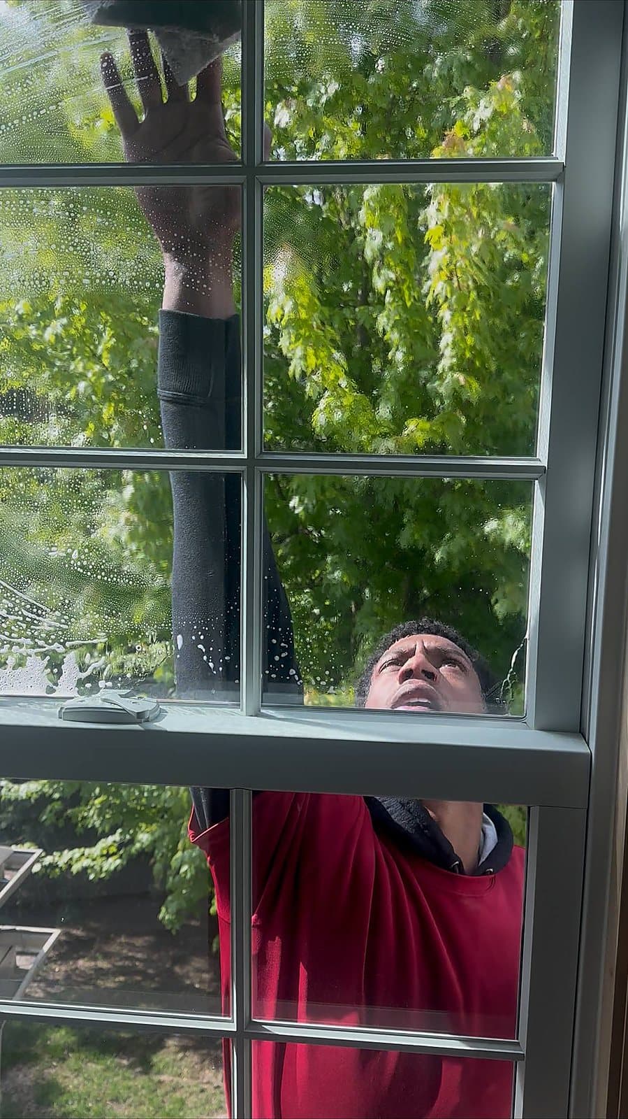 Pulling water off the glass on a window cleaning job