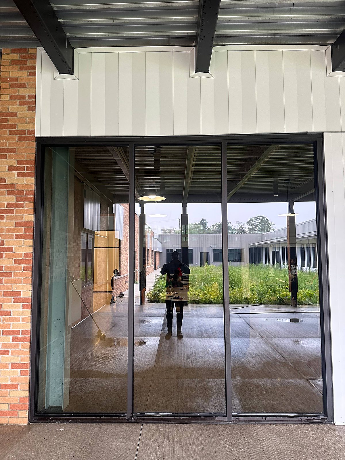 Storefront glass entry doors cleaned at a commercial building in Metro Detroit