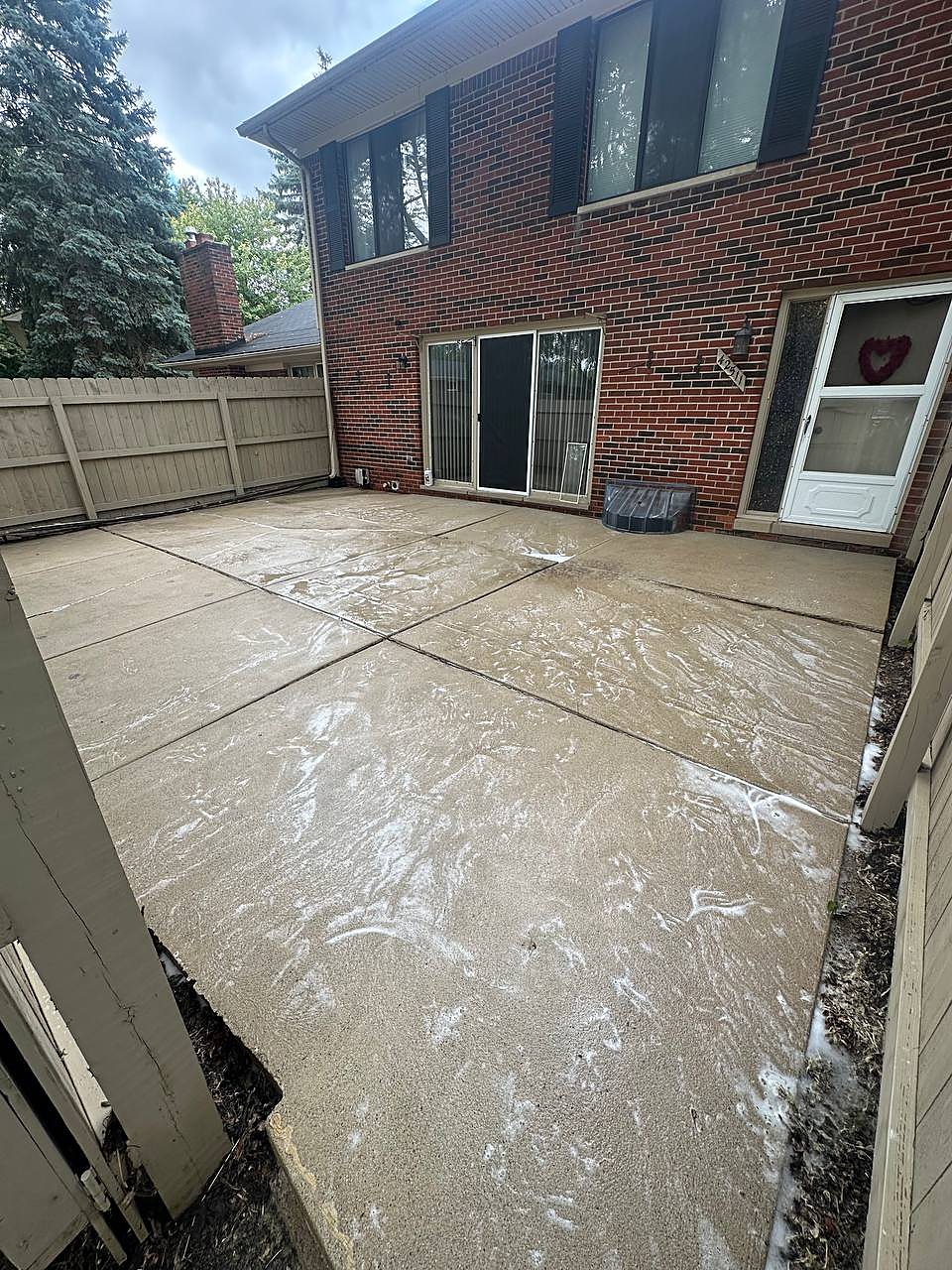 Backyard concrete patio being washed clean in Macomb, MI