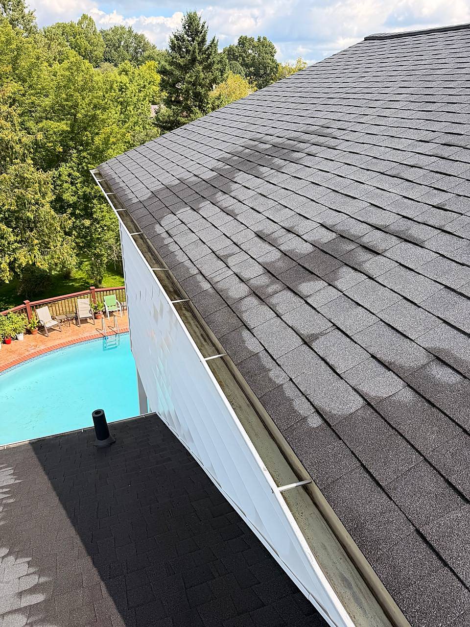 Gutter cleared along the roofline above the backyard pool in Washington Township