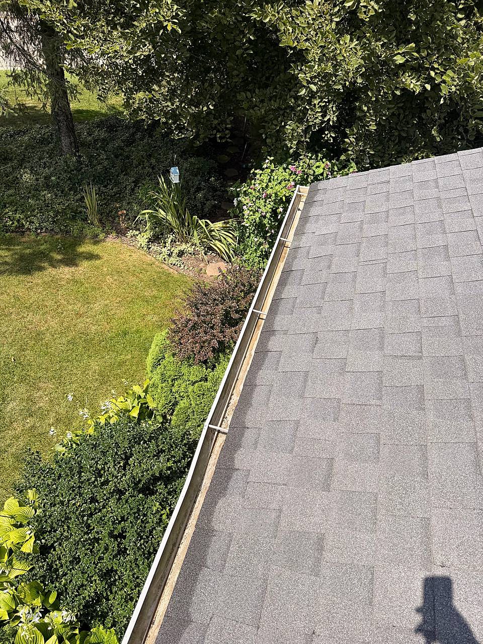 Same gutter run cleared of pine needles and debris after gutter cleaning in Macomb Township