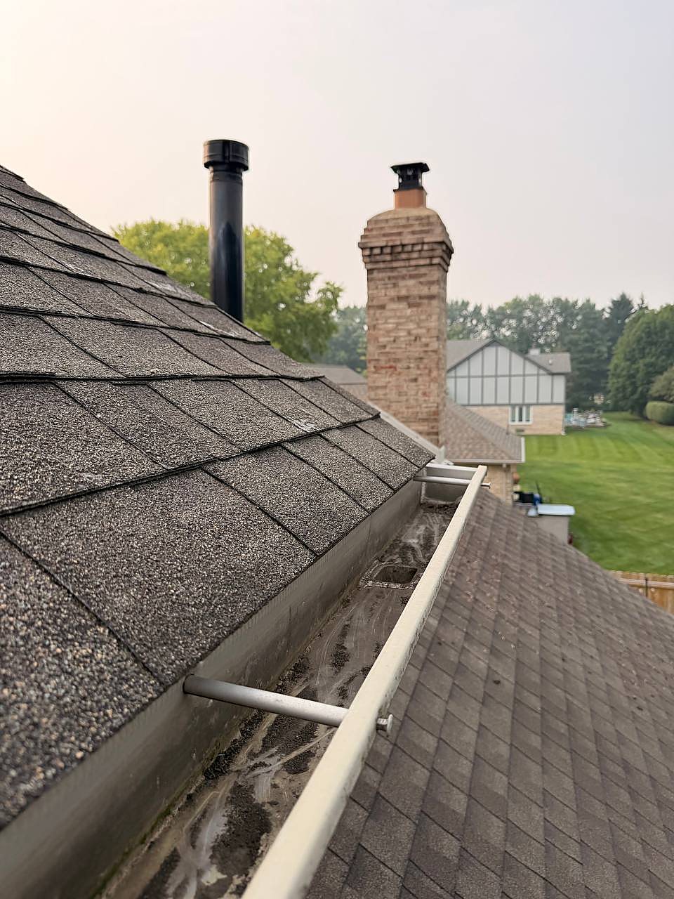 Same gutter beside the chimney flushed clear after gutter cleaning in Shelby Township