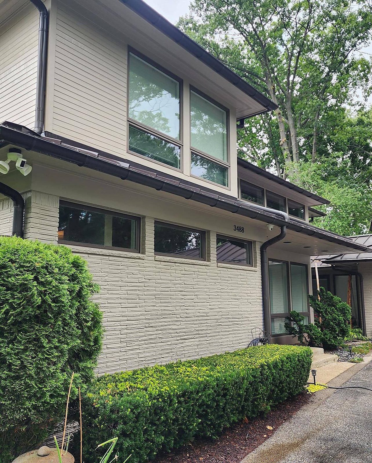 Painted brick and siding washed clean on a modern home in Macomb, MI