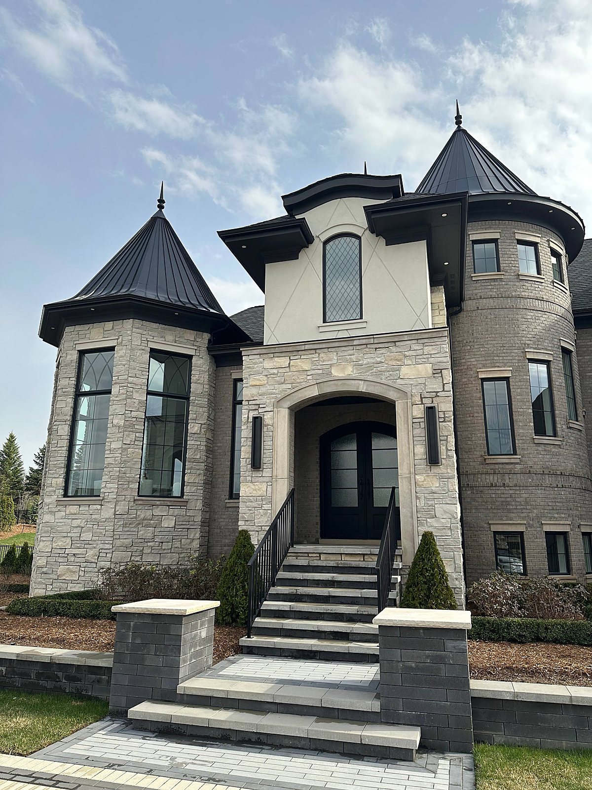 Stone castle-style home exterior, front entry cleaned in Macomb, MI