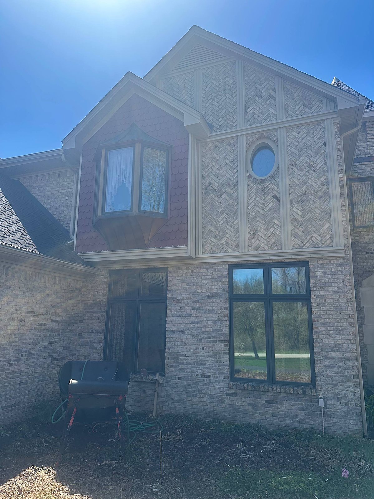 Cream brick Tudor home with bay window, cleaned in Metro Detroit