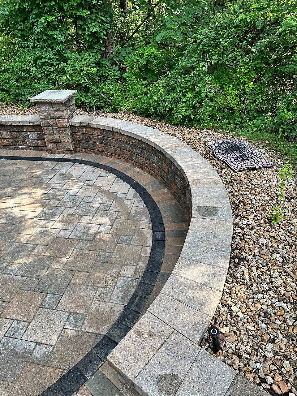 Curved paver patio and sitting wall cleaned in Macomb, MI