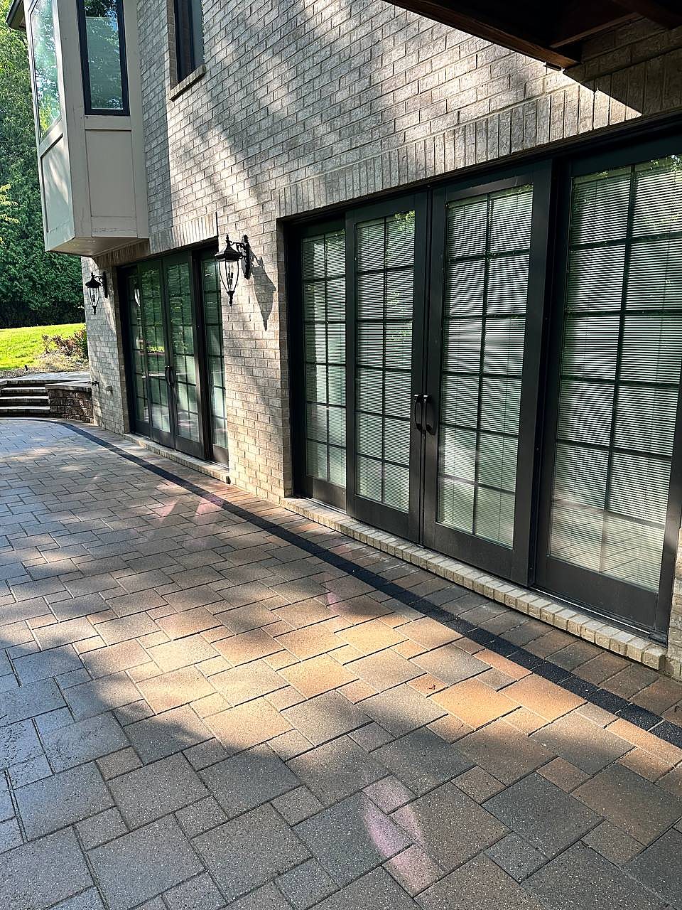 Paver walkway washed clean beside french doors