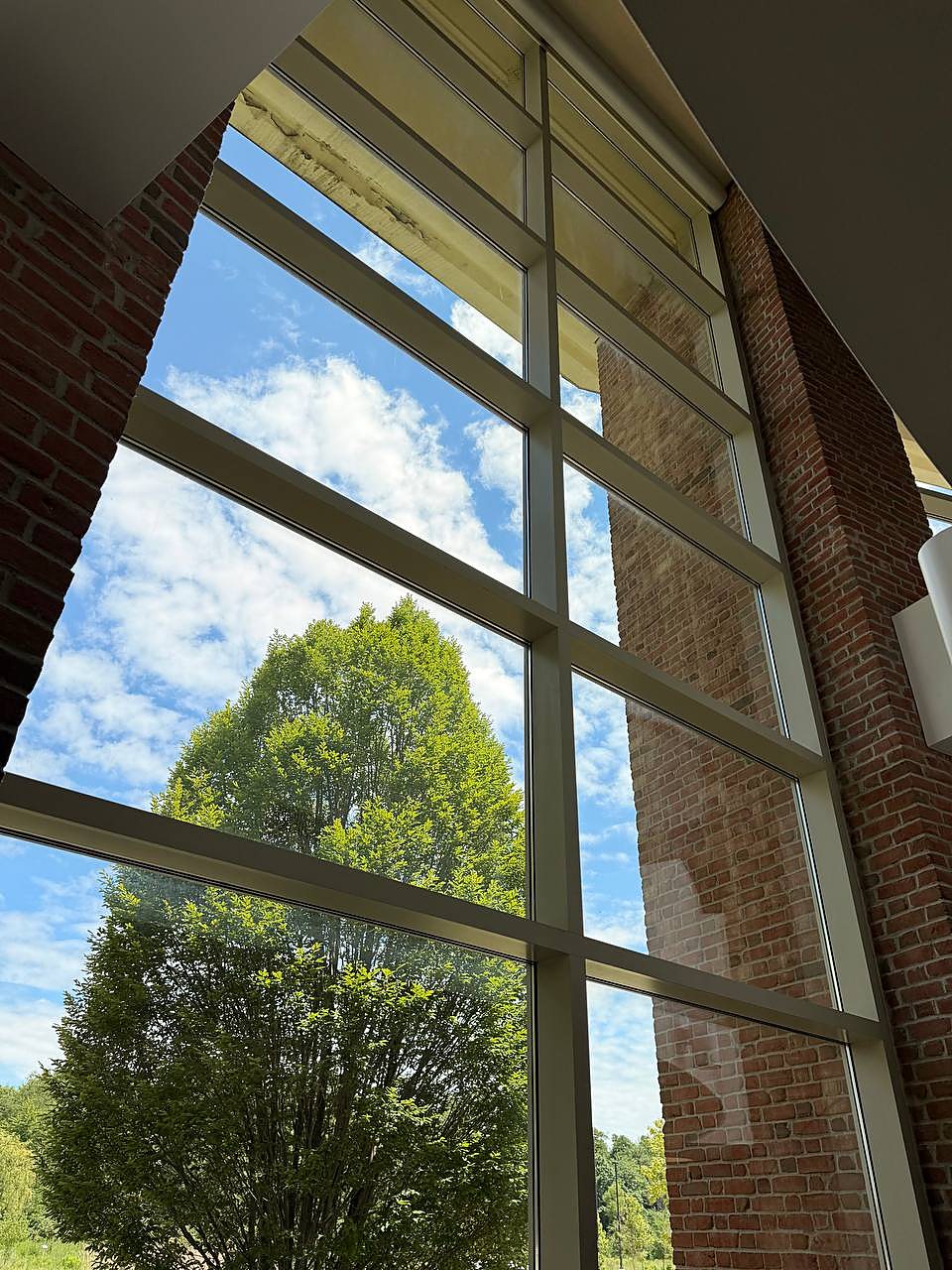 Interior atrium windows cleaned clear on a commercial building in Metro Detroit