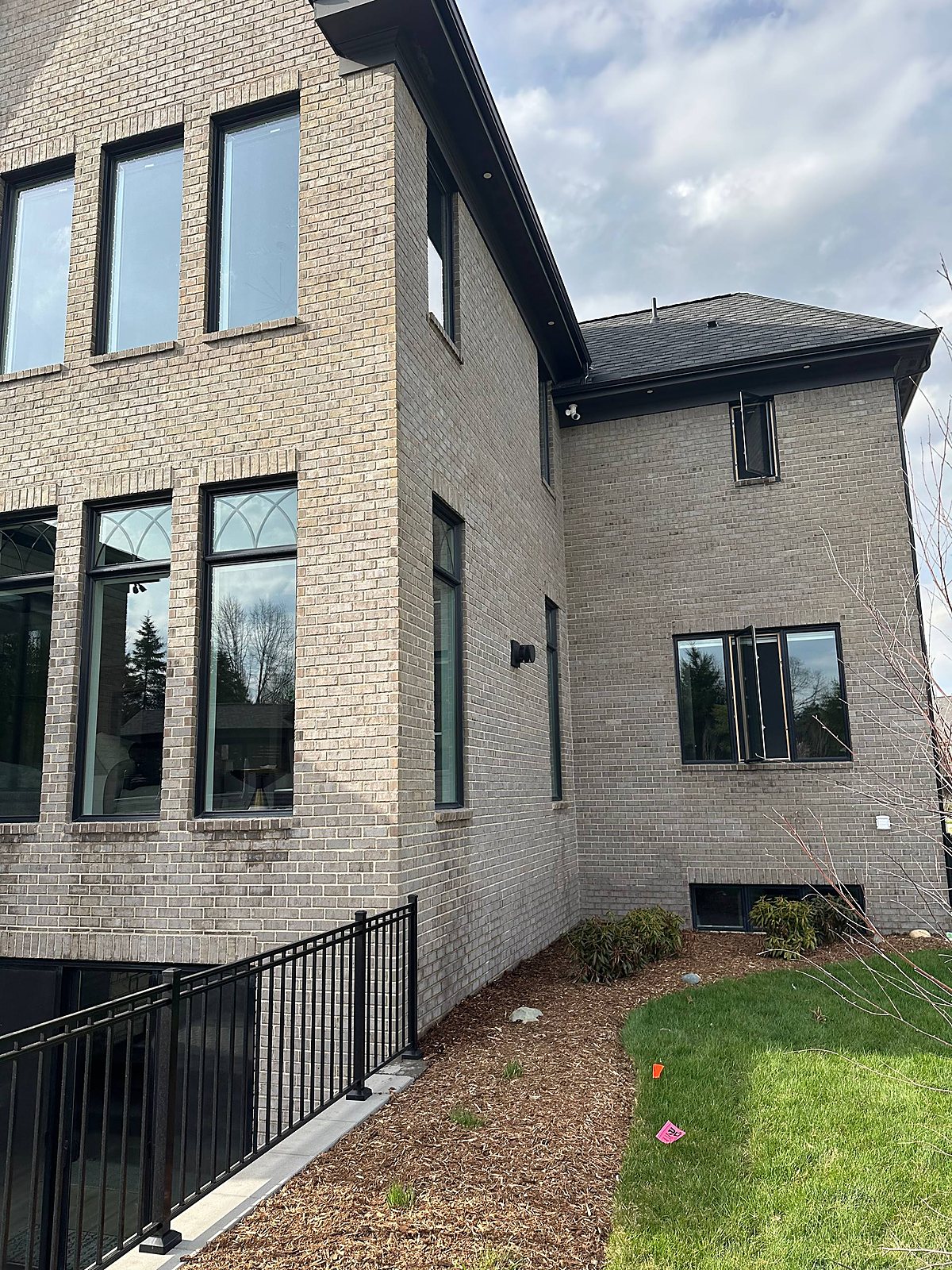 Gray brick home, corner elevation windows cleaned in Macomb, MI