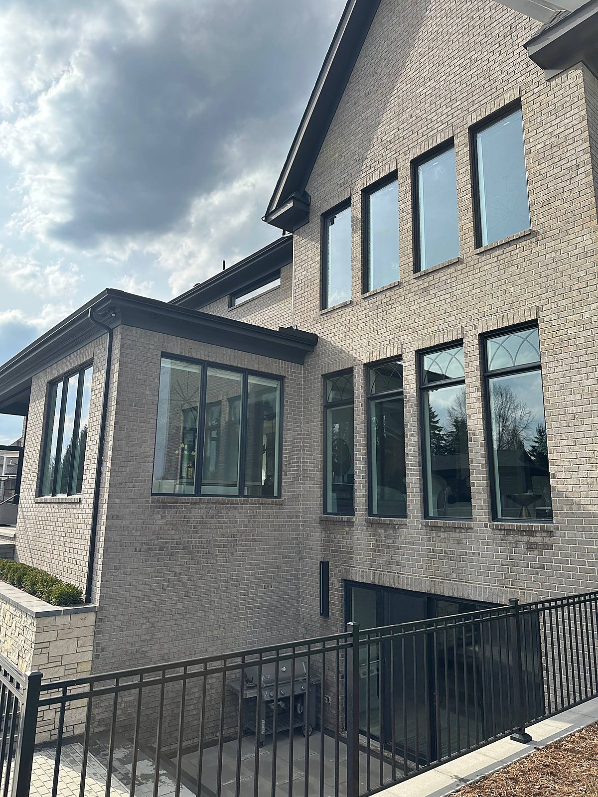 Gray brick home, multiple windows cleaned in Macomb, MI