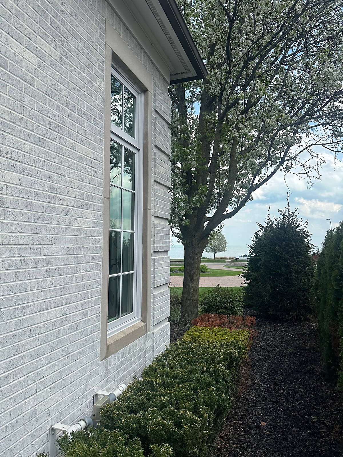 Grid window cleaned streak-free on a lakeside home in Macomb County