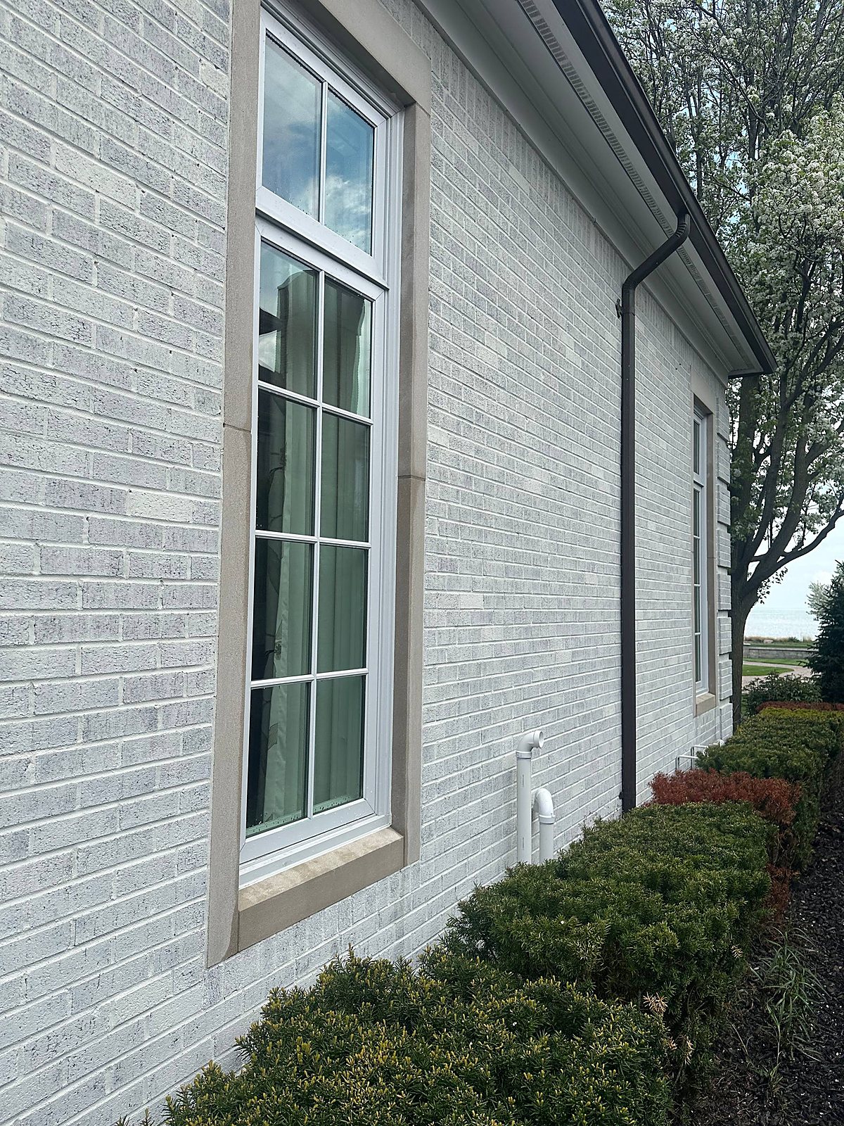 Large picture window cleaned clear with a lake view in Metro Detroit