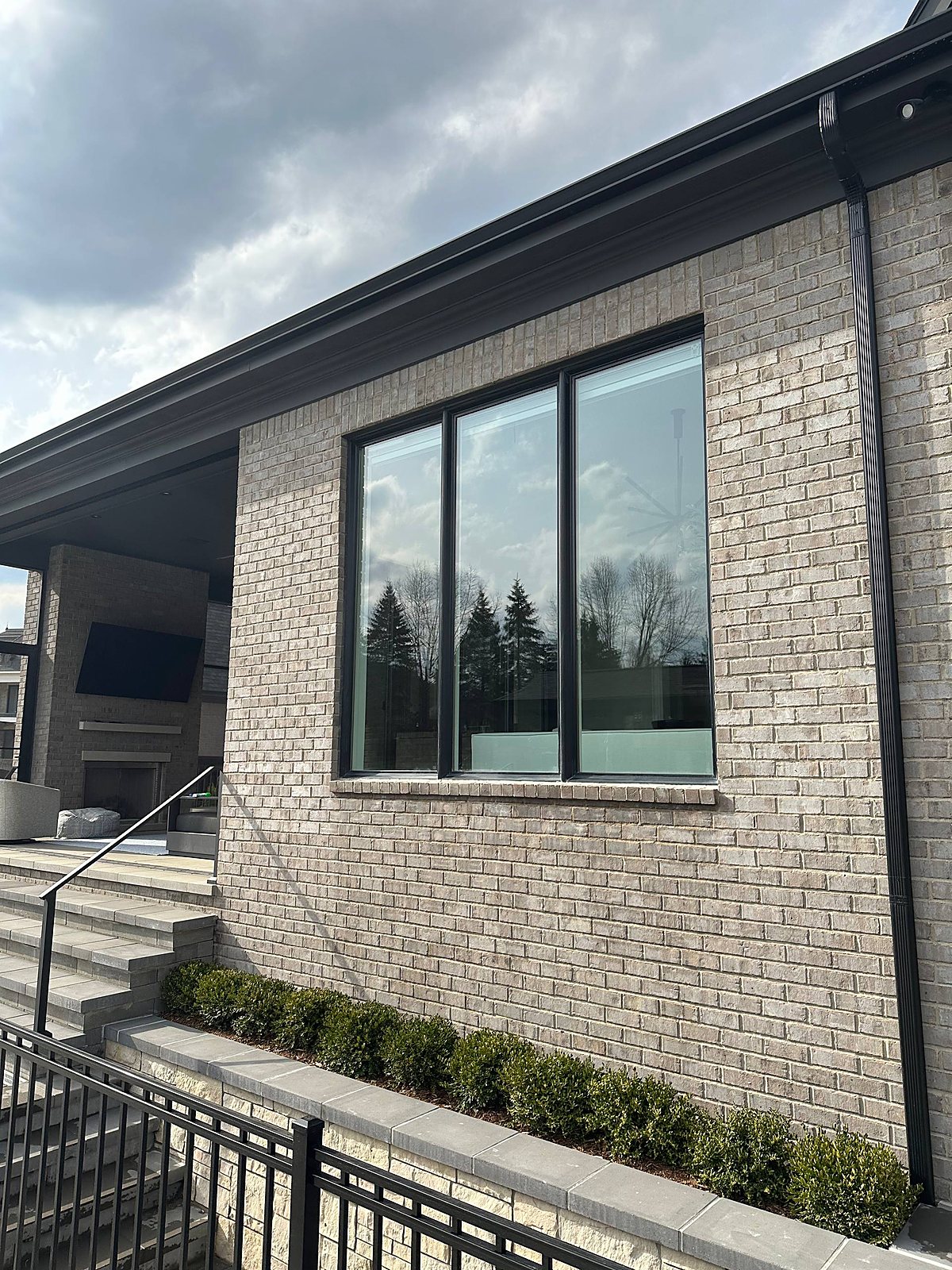 Gray brick home, tall picture windows cleaned in Metro Detroit