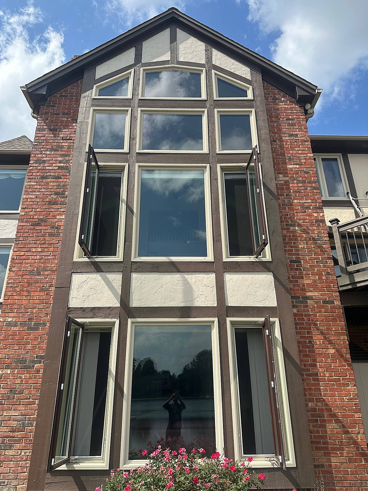 Tall bay window tower cleaned clear on a brick Tudor home in Metro Detroit